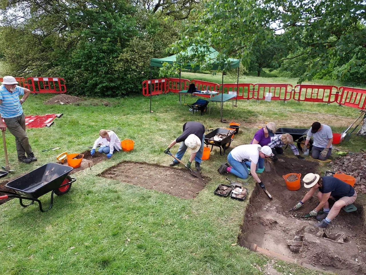 The archaeology dig at the Magnetic Observatory with volunteers digging the site.